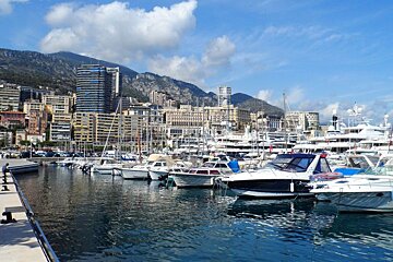 boats in the harbour in Monaco with high rise buildings behind