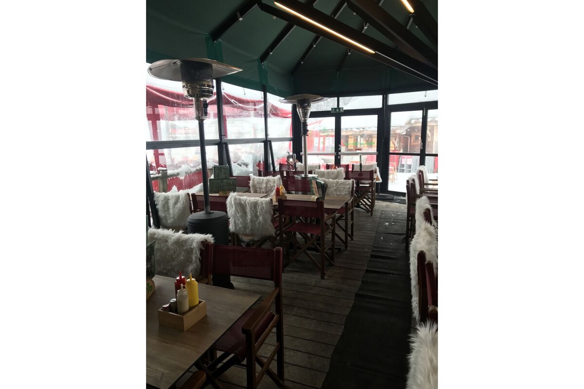 A restaurant with a lot of tables and chairs