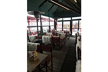 A restaurant with a lot of tables and chairs