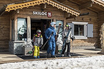 Skiers standing outside of a ski shop called skilock