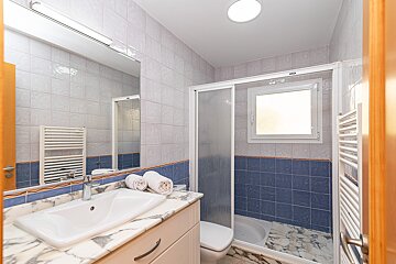 A bathroom with blue and white tiles and a sink