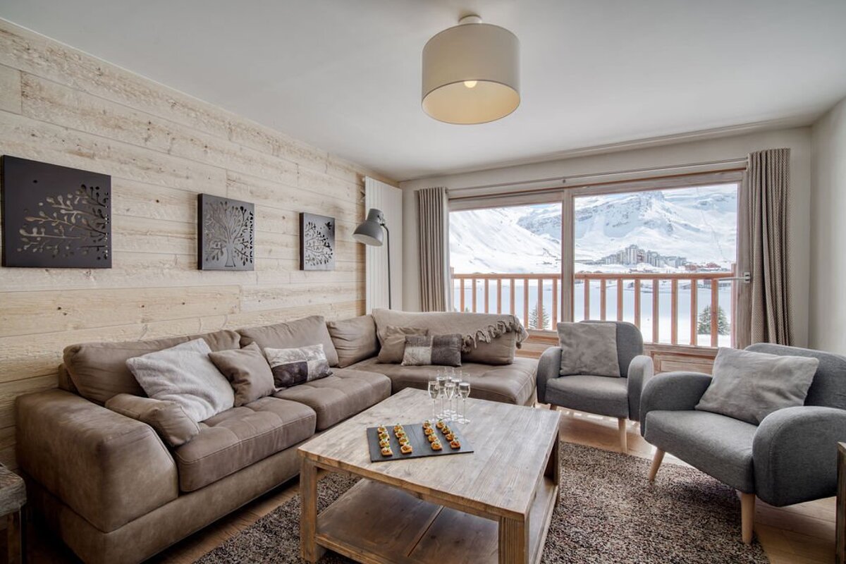 A living room with a couch and two chairs