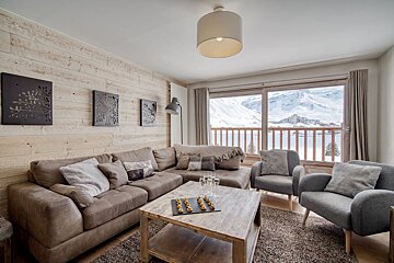 A living room with a couch and two chairs