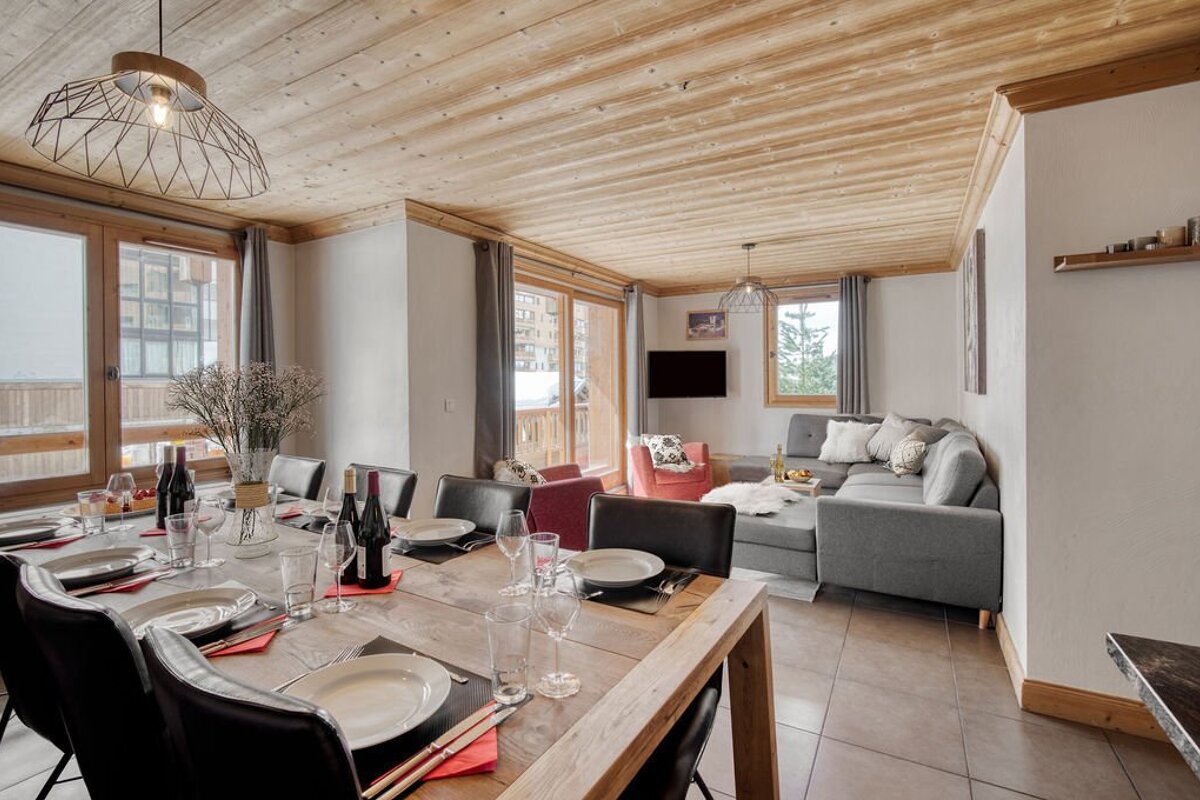 A living room with a dining table and chairs and a couch