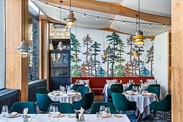 A restaurant with a painting of trees on the wall