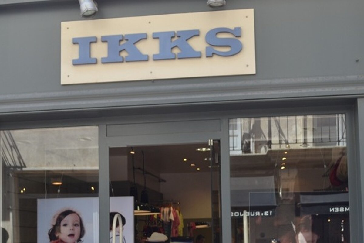 Shop front of IKKS in Avignon with a grey front and white and blue sign