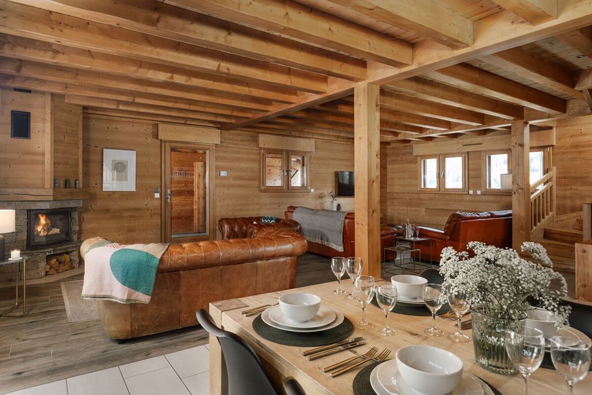 A living room with a dining table and a fireplace