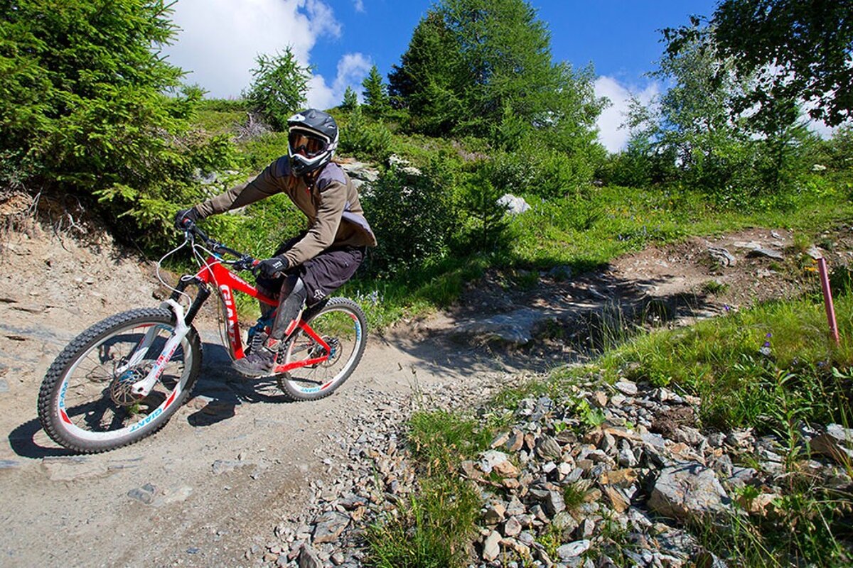 a female biker on a trail in la plagne
