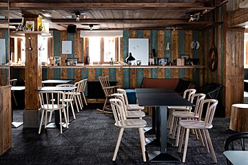 Tables and chairs in a room with a striped wall