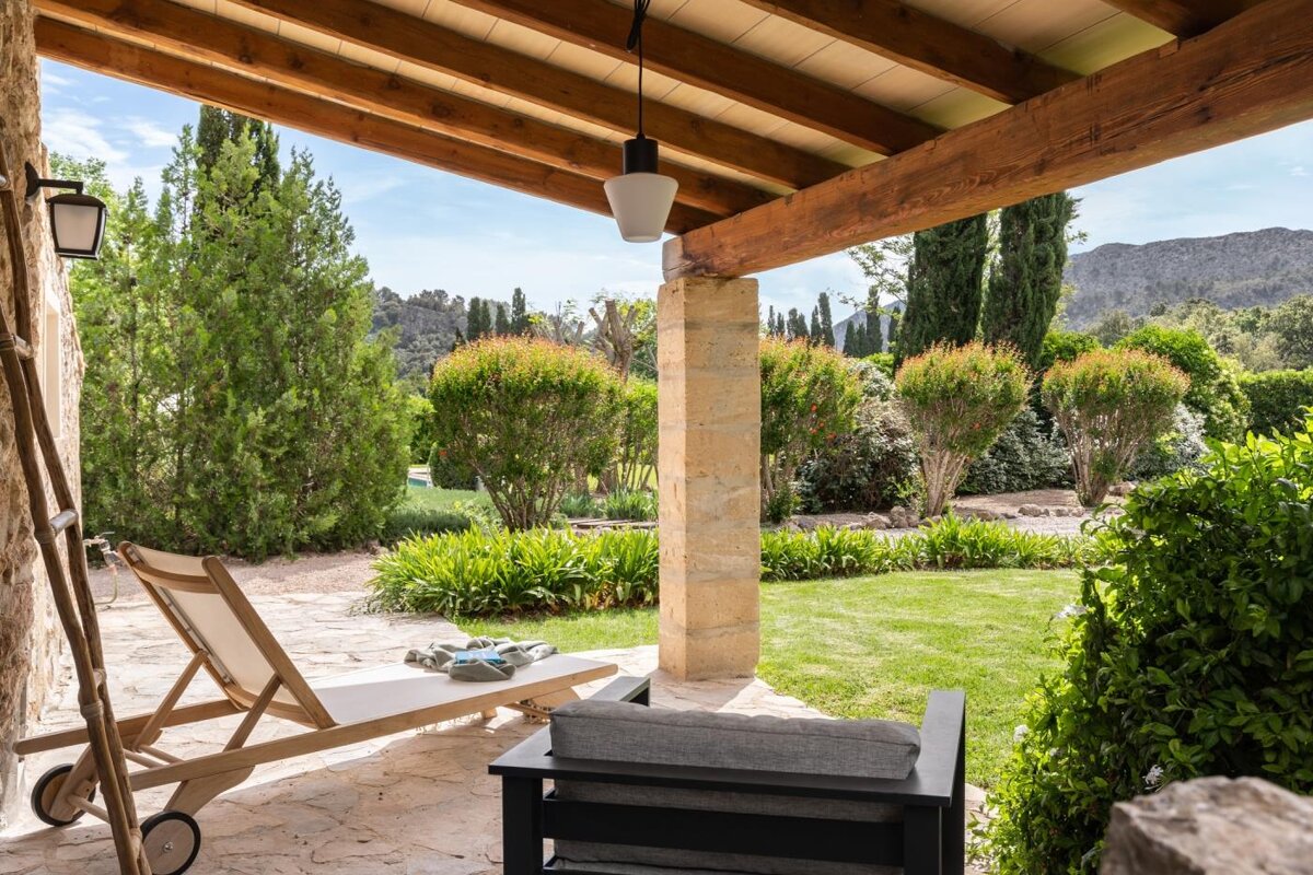 A patio with a chair and a lawn chair