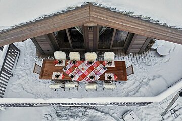 An aerial view of a table and chairs in the snow