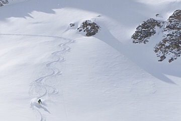 a skier coming down an off piste face