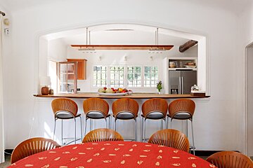 A kitchen with a table and chairs and a refrigerator