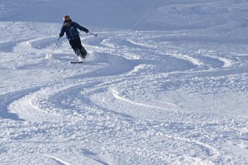 a skier in fresh snow