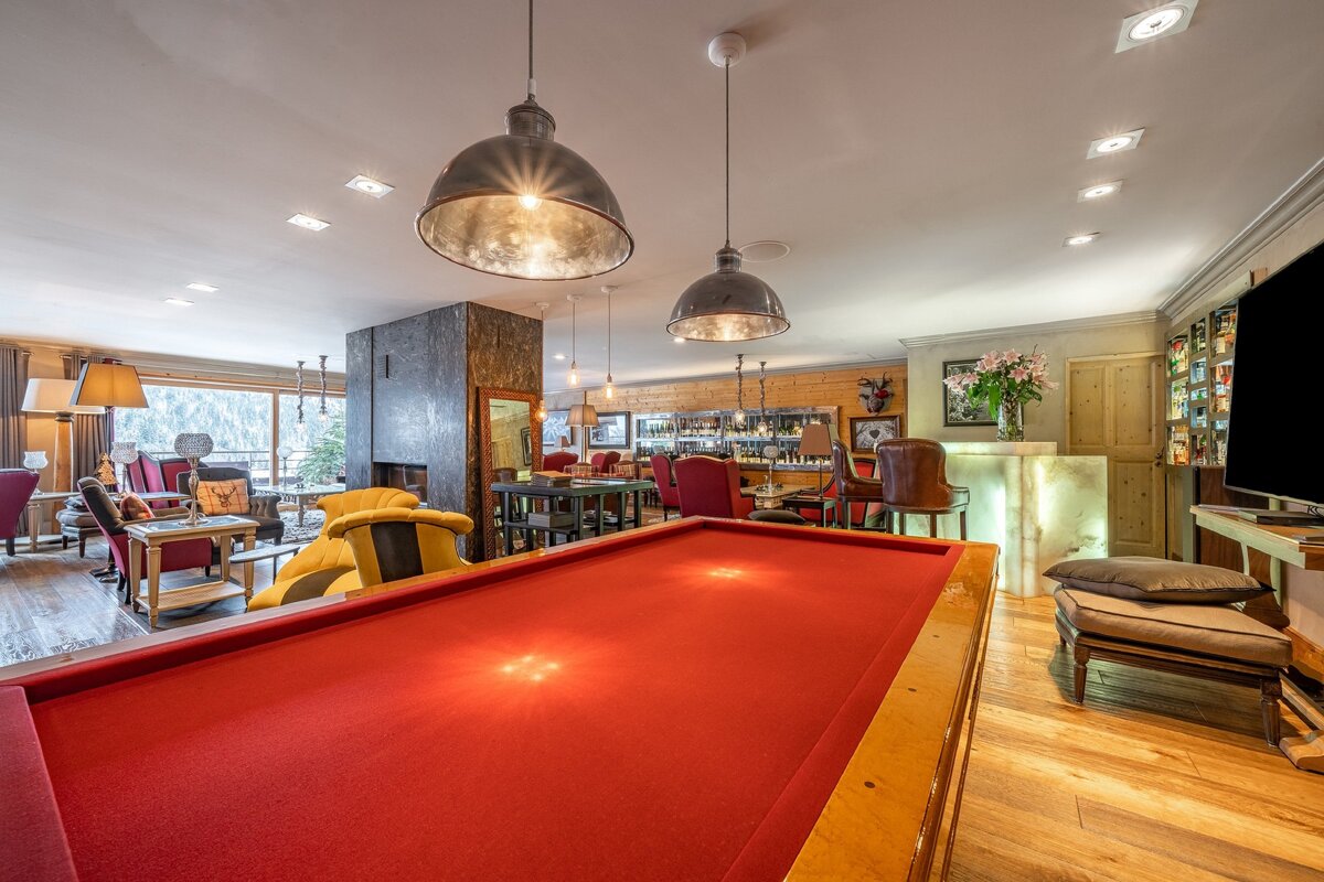 A pool table in the middle of a living room