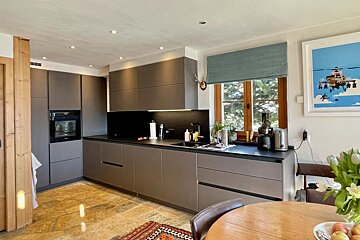 A kitchen with a picture of a ski lift on the wall