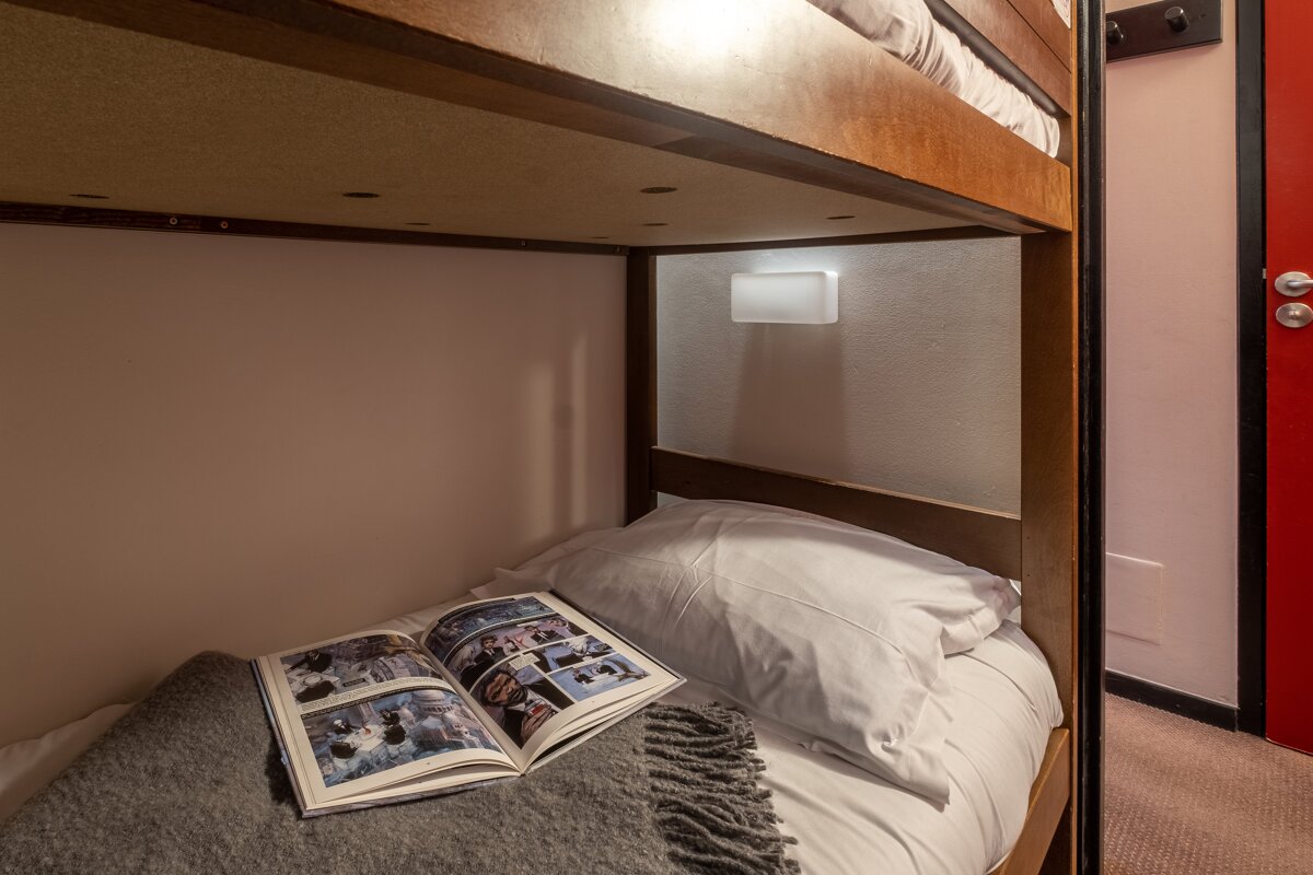 A bunk bed with a book on top of it