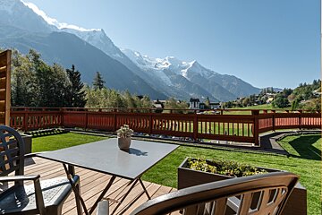 A view of a mountain range with a hotel in the foreground