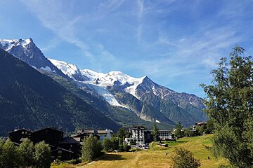 A view of a mountain range with a hotel in the foreground
