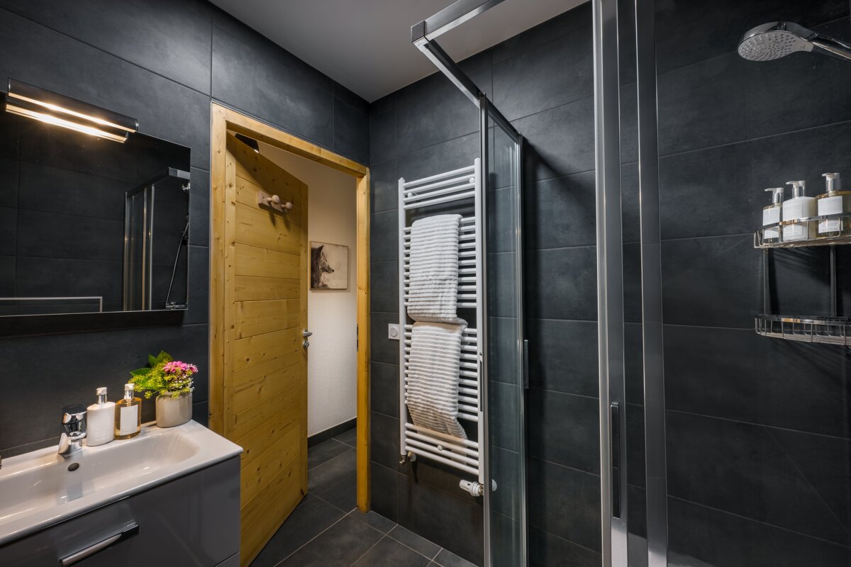 A bathroom with a sink and a towel rack