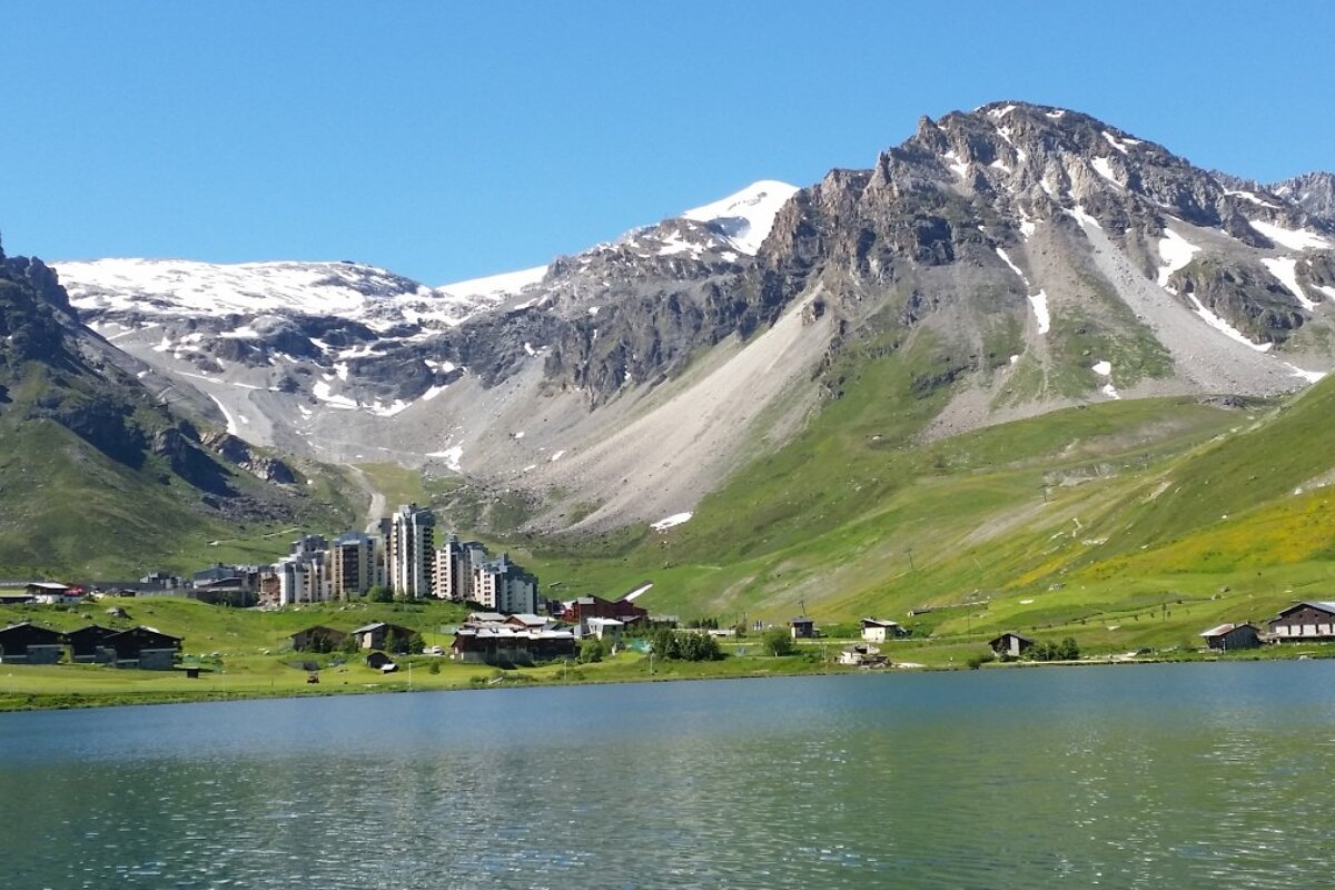 a lake in the centre of tignes in summer