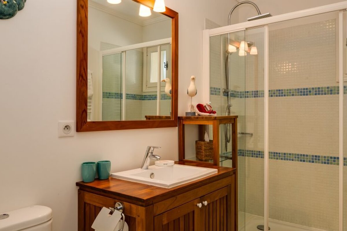 A bathroom with a sink a toilet and a shower