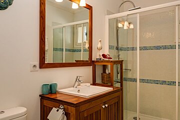 A bathroom with a sink a toilet and a shower
