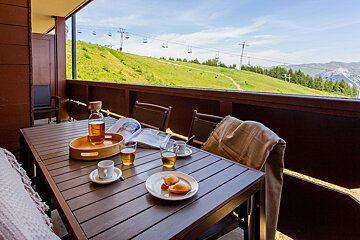 A table with a bottle of beer and a magazine on it