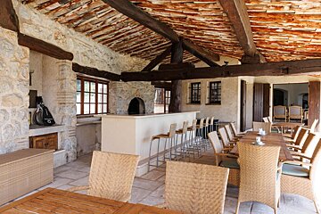 Wicker chairs and tables in a room with a bar