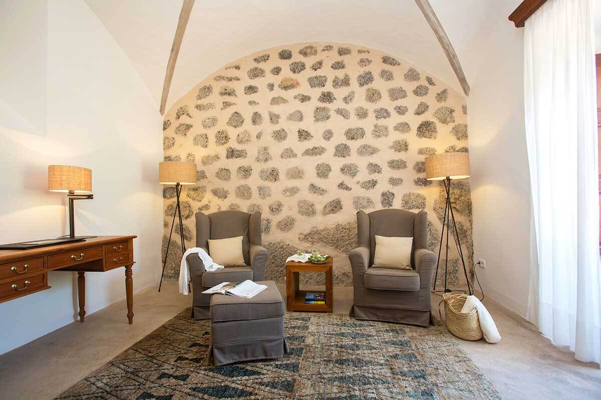 A living room with two chairs and a rug