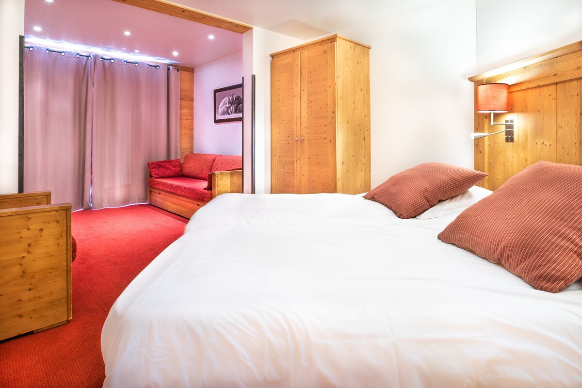 A hotel room with a bed and a couch