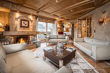 A living room with white furniture and a fireplace