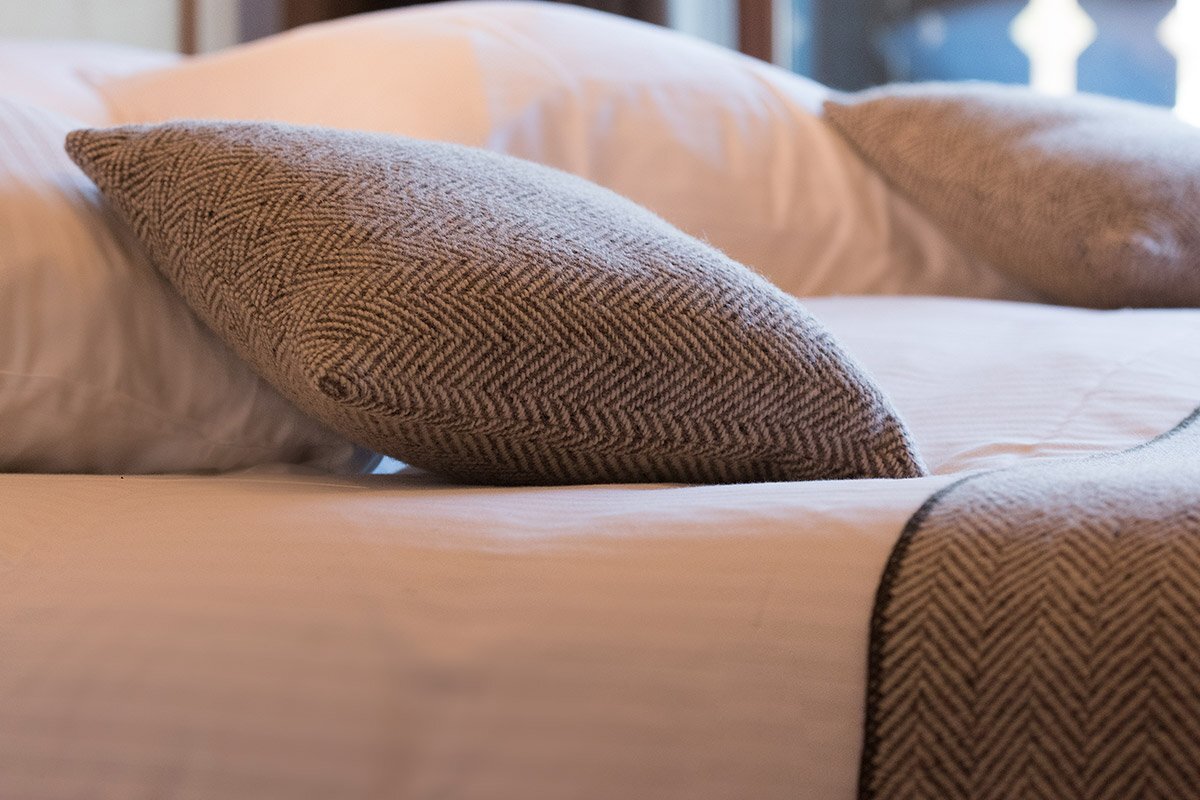 A bed with pillows and a blanket on it