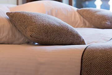 A bed with pillows and a blanket on it