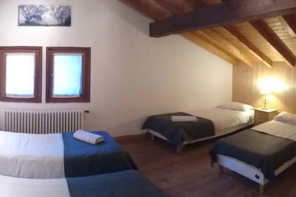 a room with multiple beds for families