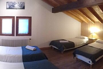 a room with multiple beds for families