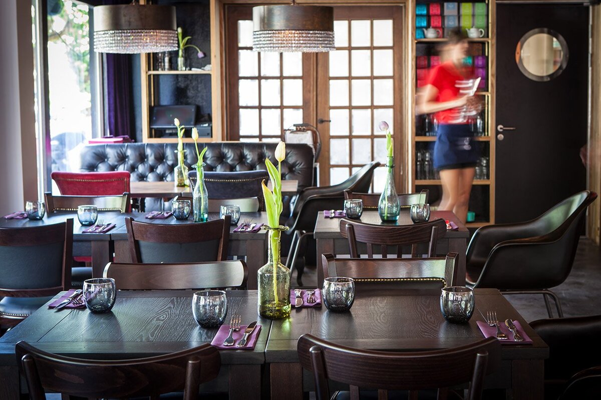 A blurred image of a waitress in a restaurant