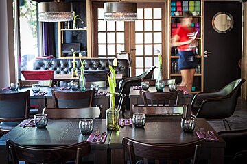 A blurred image of a waitress in a restaurant