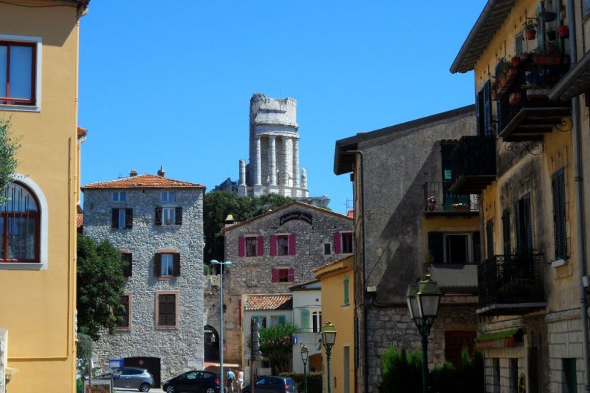 a ruined building overlooking the streets of a town
