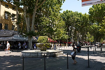 a fountain in a street in provence