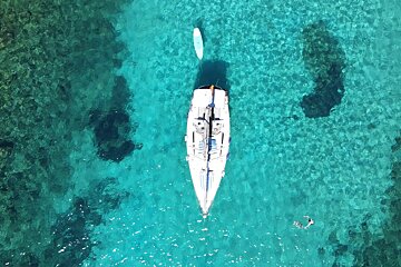 An aerial view of a sailboat in the ocean