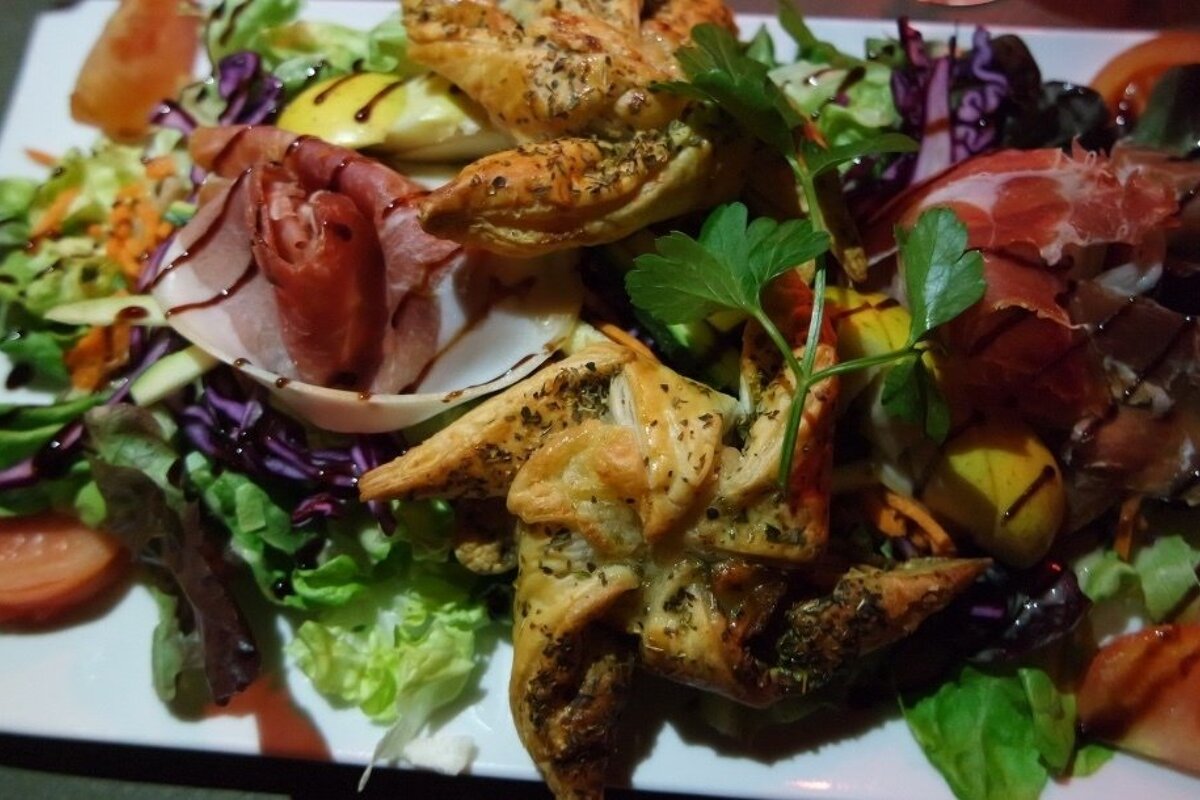 a salad with pastries in it