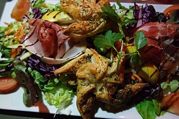 a salad with pastries in it