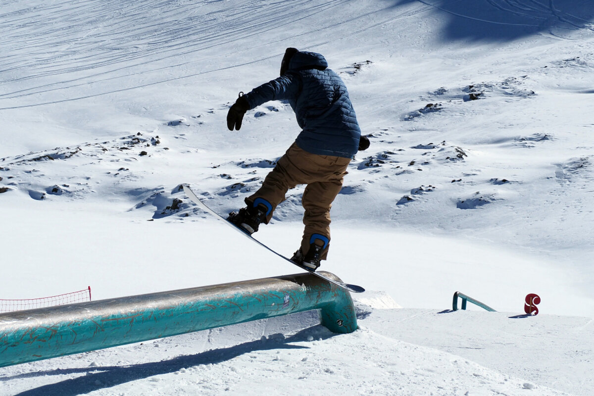 a snowboarder on a feature