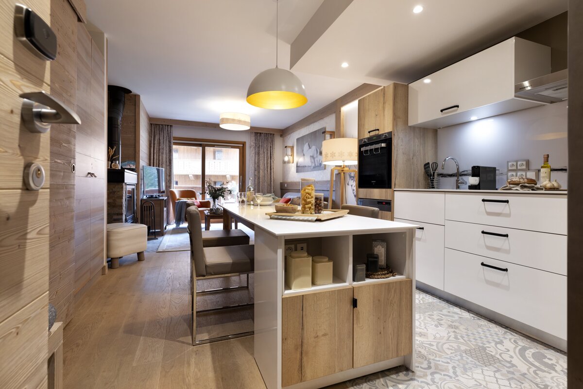 A kitchen with a table and chairs in it