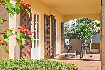 A patio with a table and chairs on it