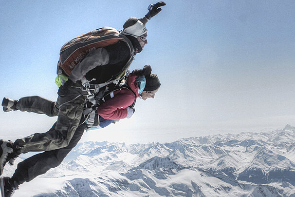 2 people skydiving above the alps
