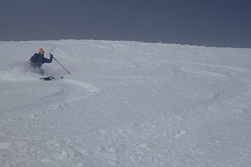 a skier in powder on an off piste route