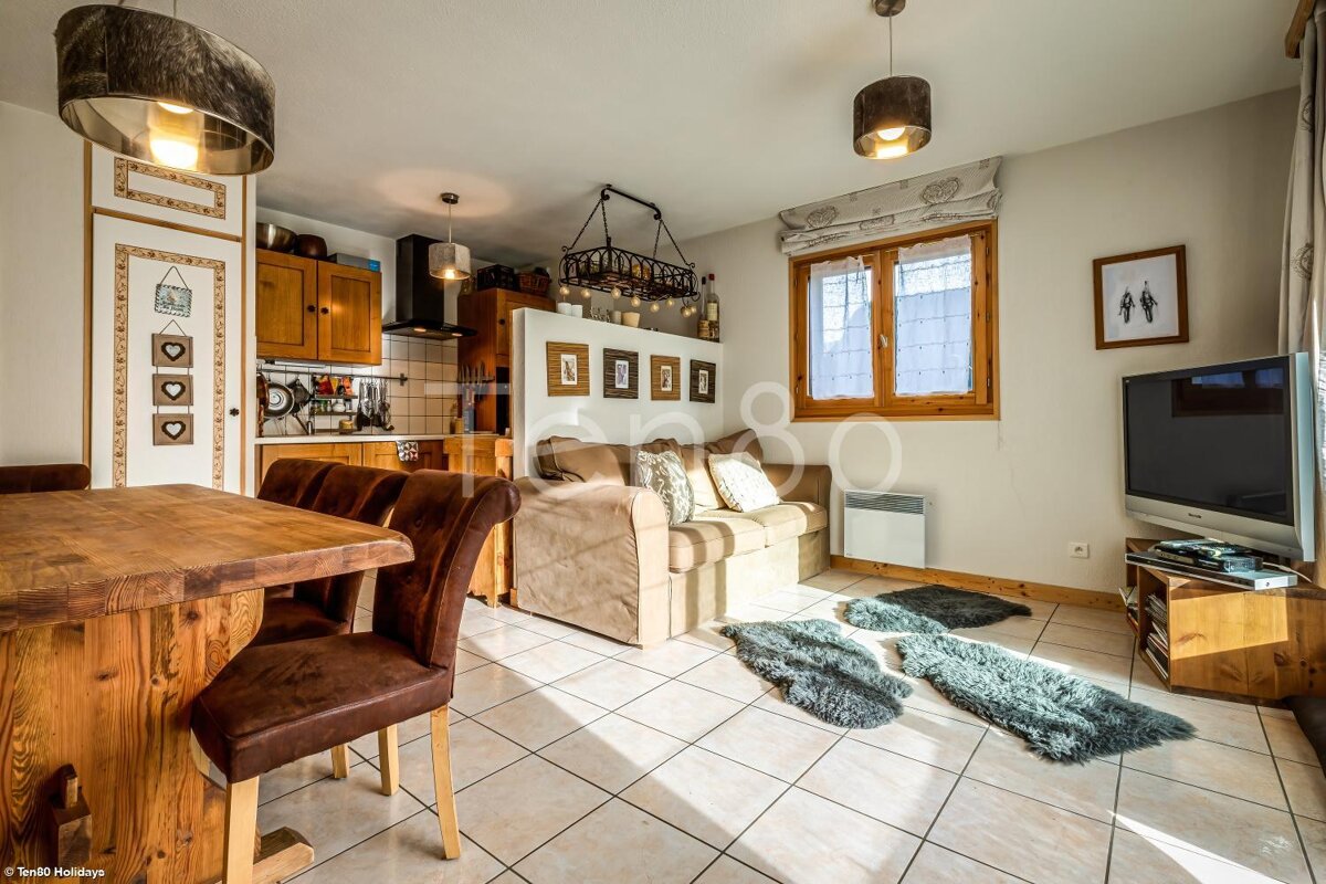 A living room with a couch and a flat screen tv