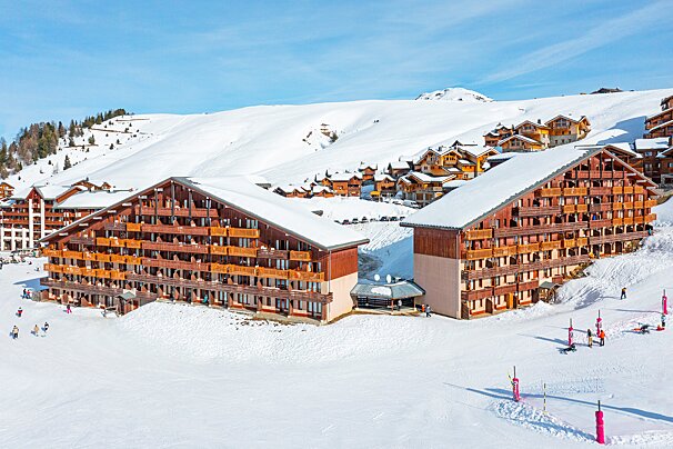 A ski resort with a lot of snow on the buildings